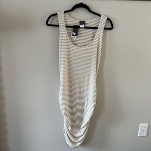 Super cute beach cover up! Poly/rayon/spandex w/ flattering ruching on bottom.